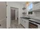 Butler's pantry features stylish cabinets, counter space, under counter wine cooler, and decorative lighting at 20 Serenity Woods Trl, Franklinton, NC 27525