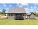Stunning view showcasing the home's gray siding, back porch, and well-manicured backyard at 20 Serenity Woods Trl, Franklinton, NC 27525