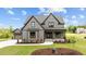 Beautiful two-story home with gray siding, black trim, and a well-manicured lawn at 20 Serenity Woods Trl, Franklinton, NC 27525