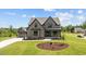 Charming two-story home with gray siding, black trim, and a manicured lawn in a lovely neighborhood at 20 Serenity Woods Trl, Franklinton, NC 27525