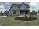 Beautifully designed two-story home with a gray facade, manicured lawn, and tasteful landscaping at 20 Serenity Woods Trl, Franklinton, NC 27525