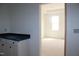 Hallway with a glimpse into the bedroom, featuring a white cabinet with black countertop at 20 Serenity Woods Trl, Franklinton, NC 27525