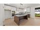 Bright open kitchen featuring a center island, wood floors, stainless appliances, and backyard views at 20 Serenity Woods Trl, Franklinton, NC 27525