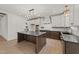 Spacious kitchen with a center island, stainless steel appliances, and elegant chandelier lighting at 20 Serenity Woods Trl, Franklinton, NC 27525