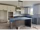 Spacious kitchen with white cabinets, dark countertops, island, and stylish lighting at 20 Serenity Woods Trl, Franklinton, NC 27525