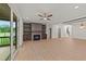 Living room featuring a fireplace, built-in shelving, and large windows with a view of the backyard at 20 Serenity Woods Trl, Franklinton, NC 27525
