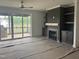 Cozy living room with fireplace, custom built-ins, and sliding glass doors to outdoor porch at 20 Serenity Woods Trl, Franklinton, NC 27525