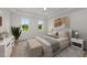Light-filled primary bedroom with large windows, neutral tones, and a cozy, inviting atmosphere at 20 Serenity Woods Trl, Franklinton, NC 27525