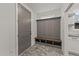 Mudroom featuring brick floor, built-in bench with cubbies, and white walls at 20 Serenity Woods Trl, Franklinton, NC 27525
