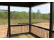 Covered porch overlooking a wooded area, perfect for relaxing and enjoying nature at 20 Serenity Woods Trl, Franklinton, NC 27525