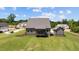 The rear exterior of the home features a covered deck and a detached garage on a large lot at 20 Serenity Woods Trl, Franklinton, NC 27525