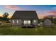 Charming home exterior featuring a covered deck and a matching detached garage at 20 Serenity Woods Trl, Franklinton, NC 27525