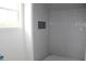 Modern tiled shower with niche and neutral color palette offering a clean and sophisticated aesthetic at 20 Serenity Woods Trl, Franklinton, NC 27525