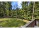 Lush backyard framed by mature trees, seen from a wooden deck at 202 Allen St # A/B, Creedmoor, NC 27522