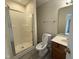 Cozy bathroom featuring a walk-in shower, toilet, sink and vanity with wood cabinets and tiled floor at 202 Allen St # A/B, Creedmoor, NC 27522