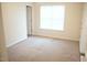 Inviting bedroom with neutral carpet, a window providing natural light, and ample closet space at 202 Allen St # A/B, Creedmoor, NC 27522