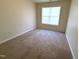 Cozy bedroom with neutral carpet and a window with blinds at 202 Allen St # A/B, Creedmoor, NC 27522