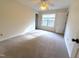 Bright bedroom featuring neutral carpet, and a window overlooking greenery at 202 Allen St # A/B, Creedmoor, NC 27522