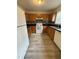 Functional kitchen with white appliances, wooden cabinets, and laminate countertops at 202 Allen St # A/B, Creedmoor, NC 27522