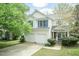 Charming two-story home with a two-car garage, manicured lawn, and mature trees at 206 Newberry Ln, Durham, NC 27703