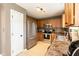 This kitchen features stainless steel appliances, granite counters, tile floors, and wood cabinets at 206 Newberry Ln, Durham, NC 27703