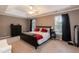 This main bedroom has a tray ceiling, large windows, and an ensuite bathroom at 206 Newberry Ln, Durham, NC 27703