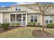 Back of house showing the screened in porch, manicured yard and tree at 207 Wildfell Trl, Cary, NC 27513