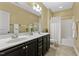 Well-lit bathroom features double vanity, granite counter and tiled floors at 207 Wildfell Trl, Cary, NC 27513