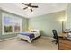 Comfortable bedroom features a ceiling fan, large window, and flexible layout at 207 Wildfell Trl, Cary, NC 27513