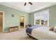 Relaxing bedroom with natural light, ceiling fan, and en suite bath access at 207 Wildfell Trl, Cary, NC 27513