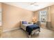 Cozy bedroom featuring natural light, neutral walls, ceiling fan and warm carpet at 207 Wildfell Trl, Cary, NC 27513
