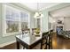 Inviting dining area features hardwood floors, backyard view, and seamless flow to the living area at 207 Wildfell Trl, Cary, NC 27513