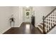 Elegant foyer with hardwood floors, staircase, and bright white trim offering a warm welcome at 207 Wildfell Trl, Cary, NC 27513