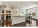 Modern kitchen featuring white cabinets, granite countertops, stainless steel appliances, and a breakfast bar at 207 Wildfell Trl, Cary, NC 27513