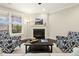 Cozy living room with a fireplace, stylish decor, and natural light creating a relaxing atmosphere at 207 Wildfell Trl, Cary, NC 27513