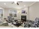 Bright living room featuring a cozy fireplace, neutral decor, and large windows with natural light at 207 Wildfell Trl, Cary, NC 27513