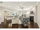 Open-concept living room with hardwood floors, a fireplace, and seamless connection to the kitchen at 207 Wildfell Trl, Cary, NC 27513