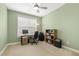 Bright office features a ceiling fan, large window and neutral carpet at 207 Wildfell Trl, Cary, NC 27513