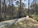Scenic path leading to a bridge surrounded by lush greenery and mature trees at 207 Wildfell Trl, Cary, NC 27513