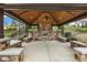 Outdoor pavilion features wood beamed roof, stone fireplace and concrete flooring at 207 Wildfell Trl, Cary, NC 27513
