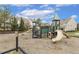 Community playground with green turrets and tan slides and wood chip ground covering at 207 Wildfell Trl, Cary, NC 27513