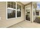 Cozy screened porch with large windows, offering a glimpse into the home's dining area, providing a relaxing transition space at 207 Wildfell Trl, Cary, NC 27513