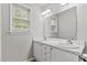 Bright bathroom with double sink vanity, large mirror, and natural light at 2100 Thornblade Dr, Raleigh, NC 27604