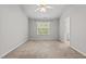 Neutral bedroom featuring a large window providing natural light and neutral carpet at 2100 Thornblade Dr, Raleigh, NC 27604