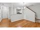 Open dining area featuring hardwood floors, neutral paint colors, and adjacent to kitchen and stairs at 2100 Thornblade Dr, Raleigh, NC 27604