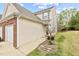 A tan two-story house with white trim, a brick-accented garage, and a tidy front yard at 2100 Thornblade Dr, Raleigh, NC 27604