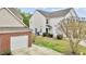 A two-story home with white siding, a brick-accented garage, and a green yard at 2100 Thornblade Dr, Raleigh, NC 27604