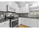 Well-equipped kitchen boasting stainless steel appliances, granite counters, stylish backsplash, and ample cabinet space at 2100 Thornblade Dr, Raleigh, NC 27604