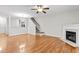 Open living space featuring hardwood floors, fireplace, stairs, and view of the kitchen at 2100 Thornblade Dr, Raleigh, NC 27604