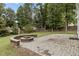 A backyard has a circular stone fire pit and brick patio, great for entertaining outdoors at 2112 Queensway Ct, Creedmoor, NC 27522